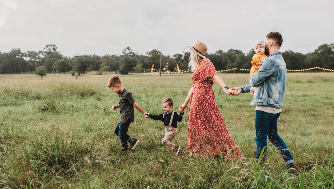 Family with kids walking in a field